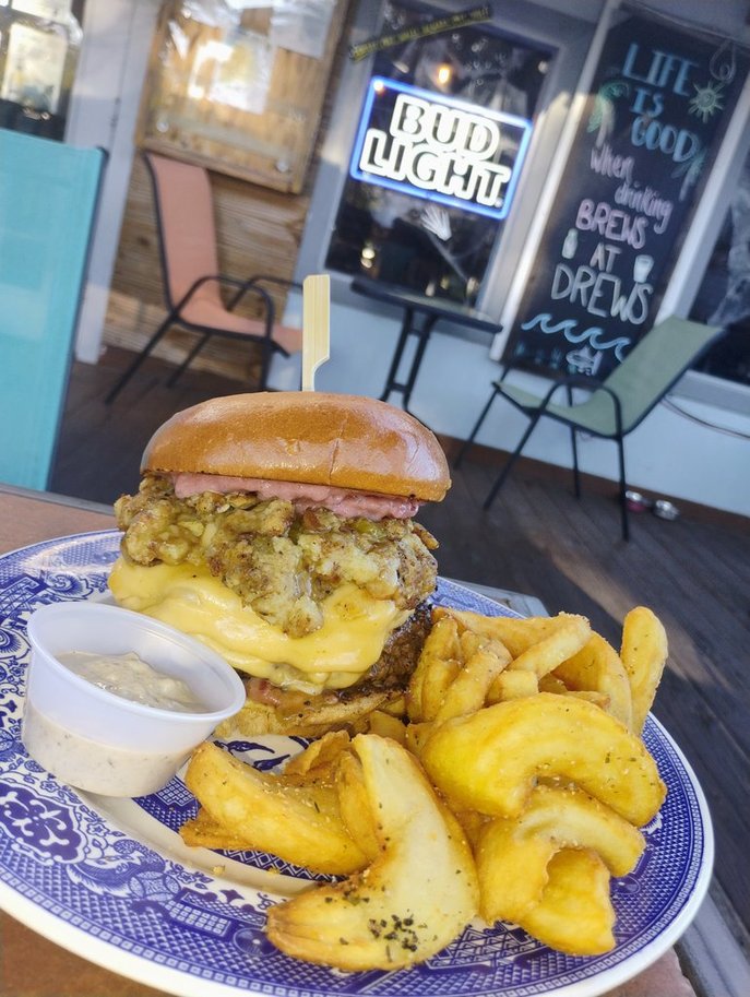 A handcrafted burger with melted cheese and gravy at Drews Brews and Grille